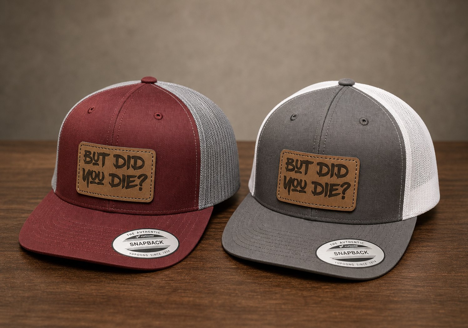 Maroon and gray snapback hats with But did you die leather patches.