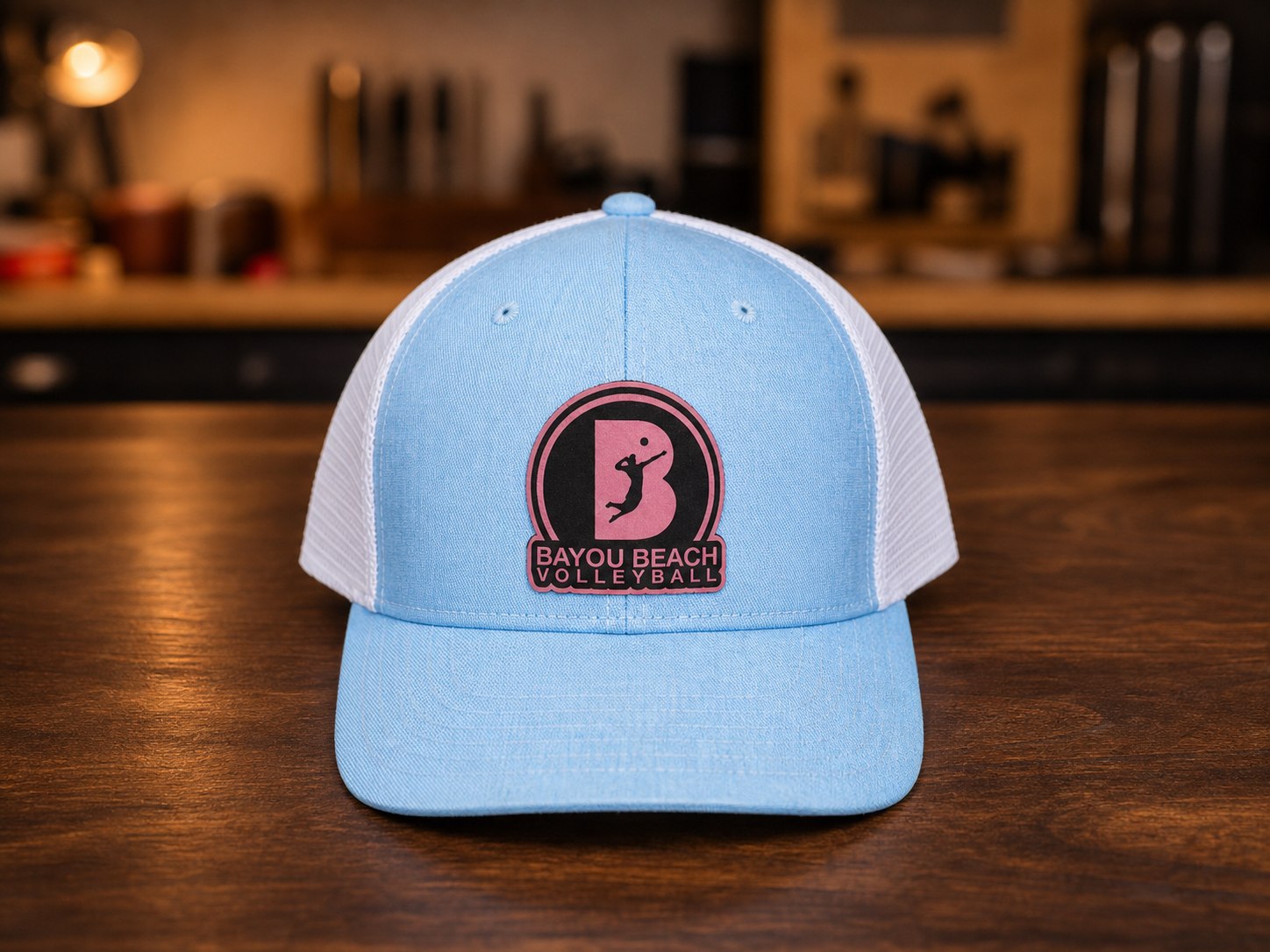 Light blue mesh hat with Bayou Beach Volleyball patch.