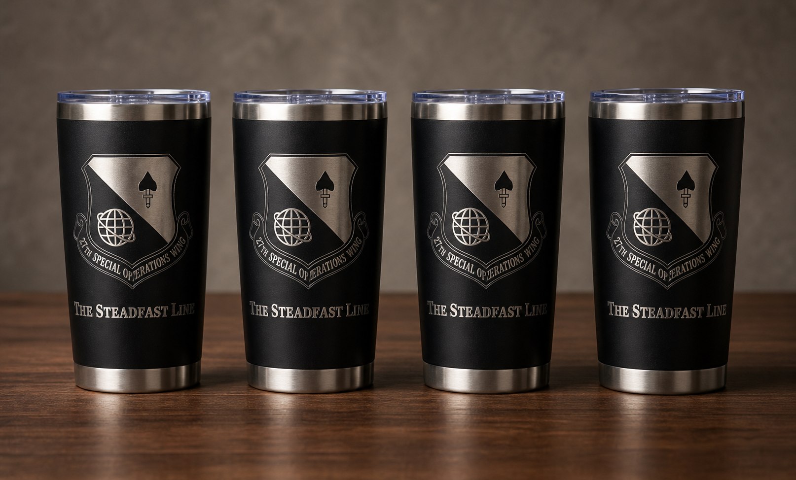 Four black stainless tumblers engraved with 27th Special Operations Wing artwork.